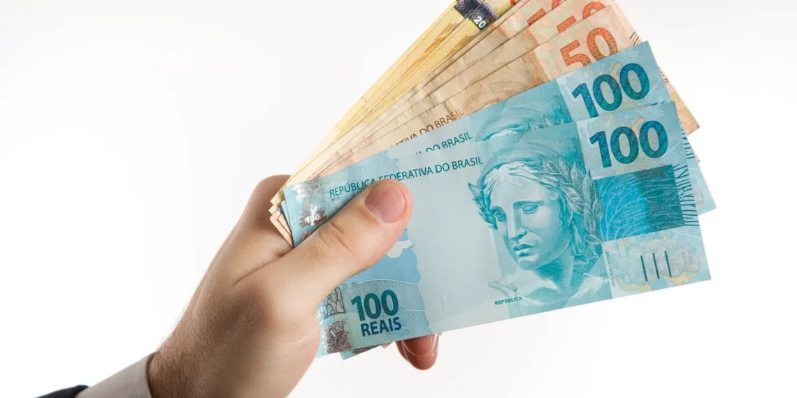 holding-brazilian-money-scaled